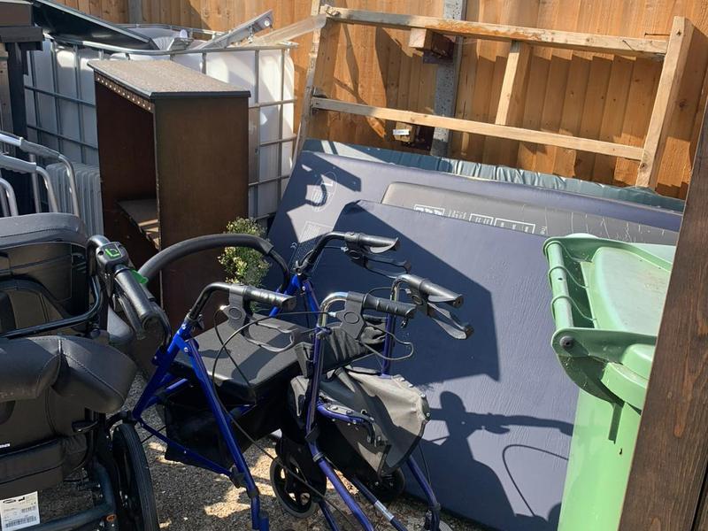 Mixed garden waste and unwanted items before clearance